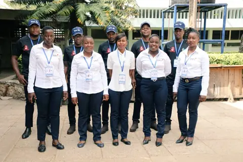 Players and officials in matching uniforms standing together outdoors